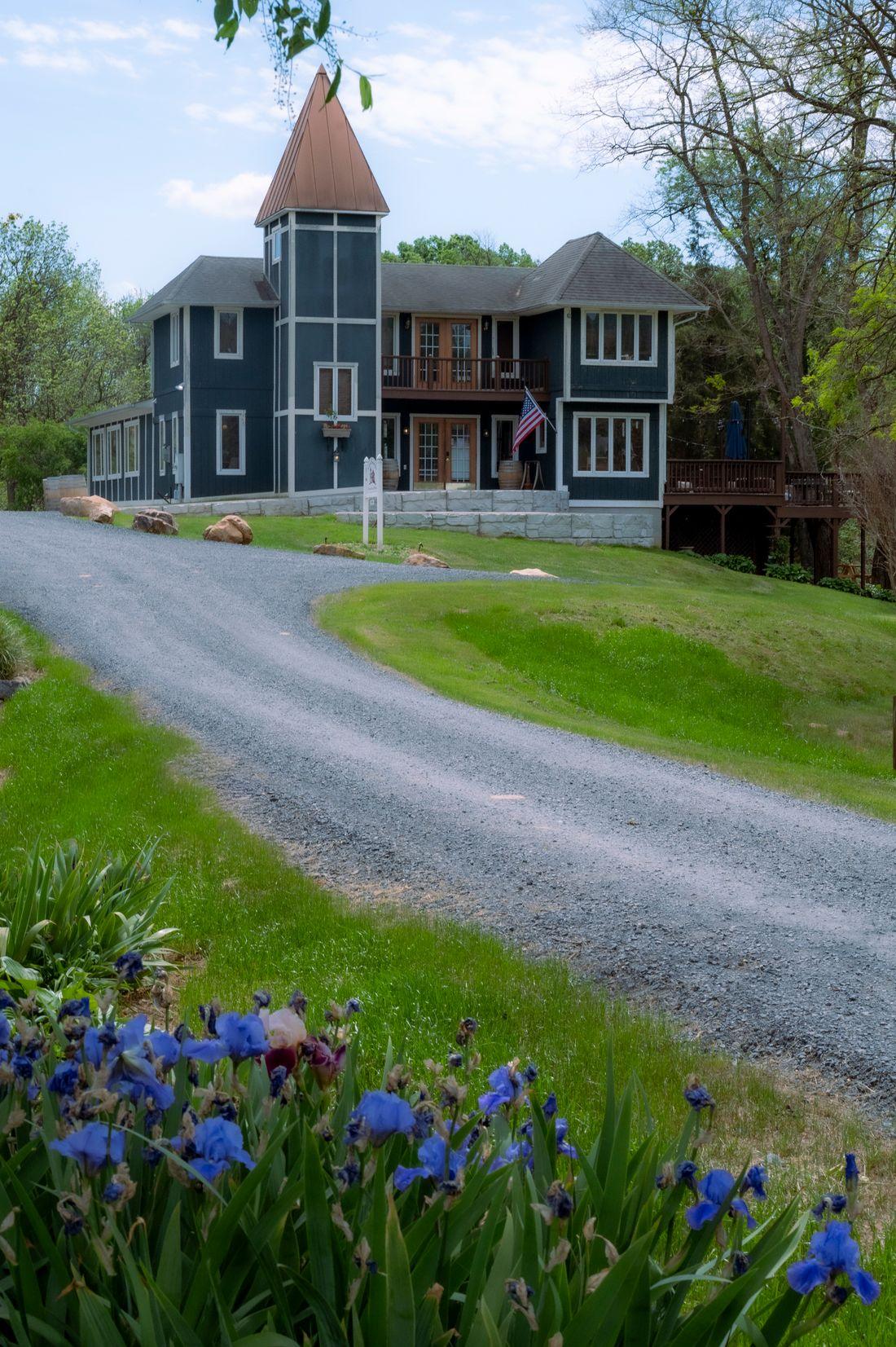 A gravel driveway curving up to a house