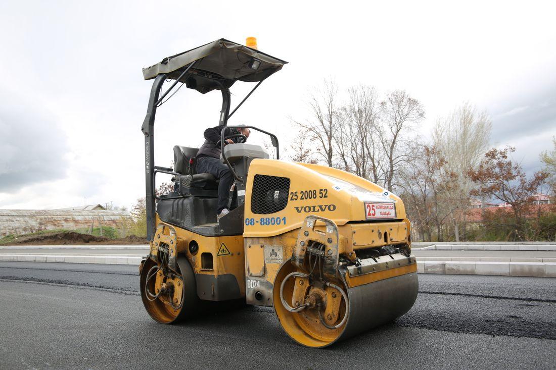 A roller compacting a new layer of asphalt