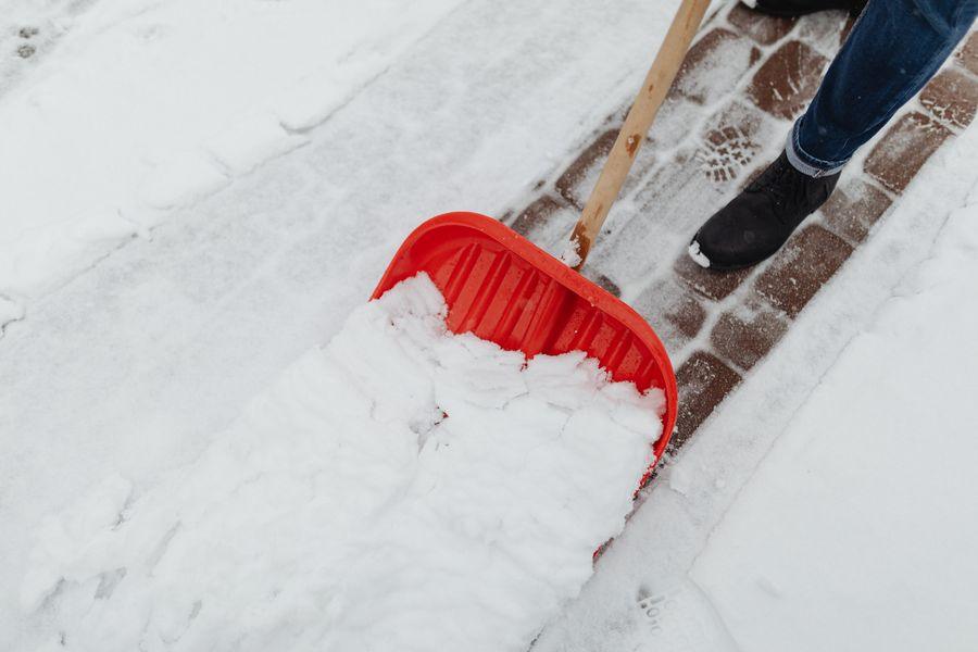 A red snow shovel clearing a path