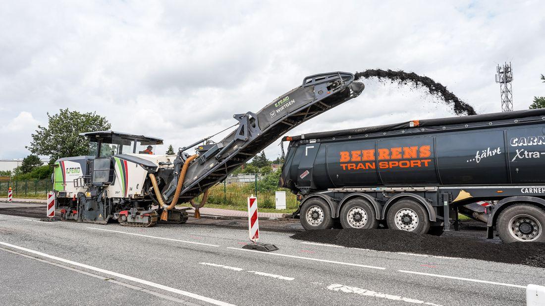 A milling machine grinding off worn asphalt